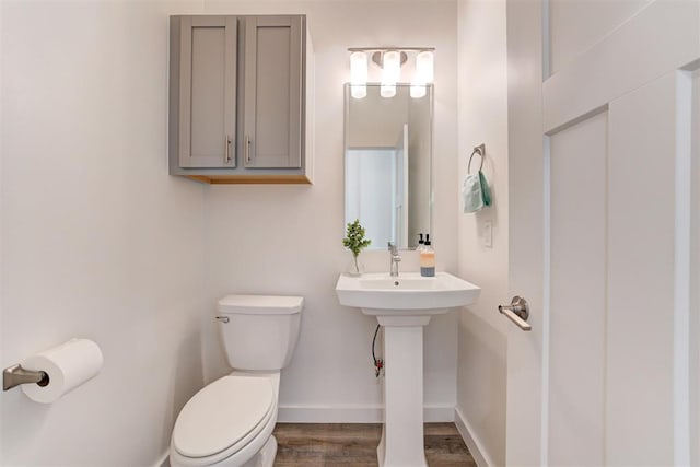 bathroom with wood-type flooring and toilet