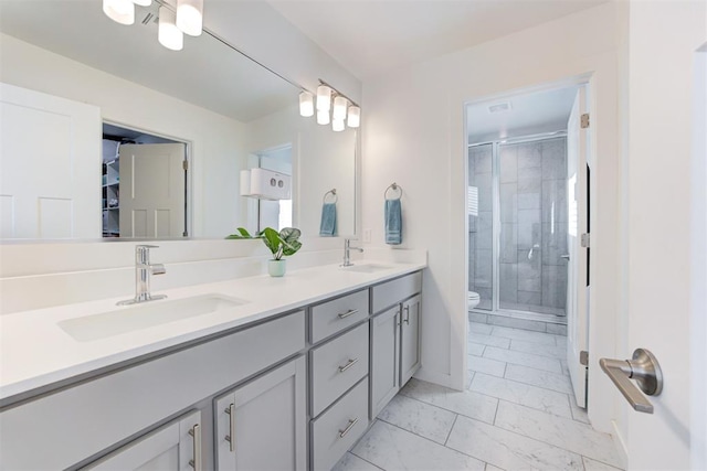 bathroom featuring vanity, toilet, and an enclosed shower