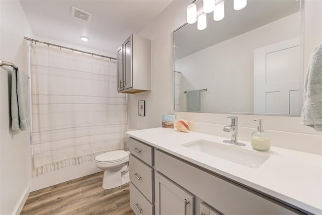 bathroom with vanity, hardwood / wood-style floors, and toilet