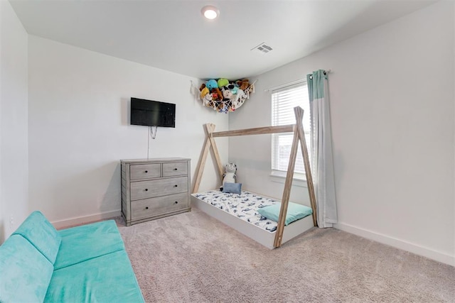 bedroom featuring light carpet