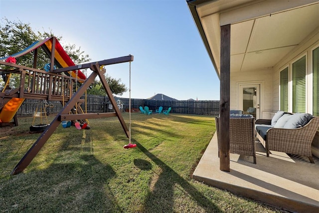 view of playground featuring a yard and a patio