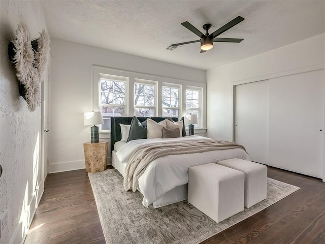 bedroom featuring visible vents, dark wood finished floors, and multiple windows