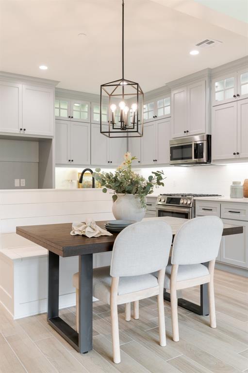 616 Montauk Way, Edmond, OK 73034 - kitchen featuring recessed lighting, a notable chandelier, light wood-style floors, and appliances with stainless steel finishes