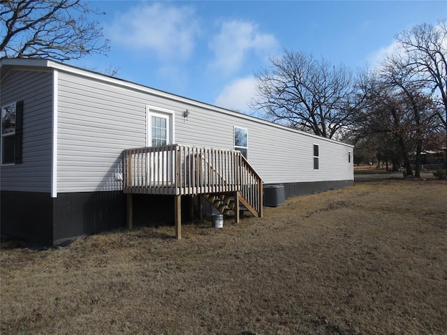 back of house featuring a wooden deck and central AC