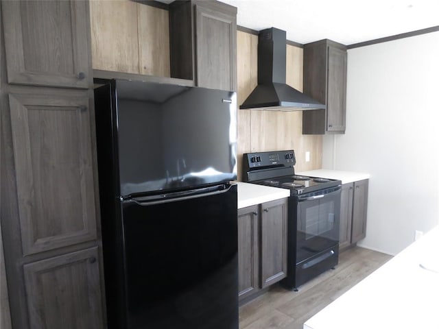 kitchen featuring wall chimney range hood, light wood-type flooring, and black appliances