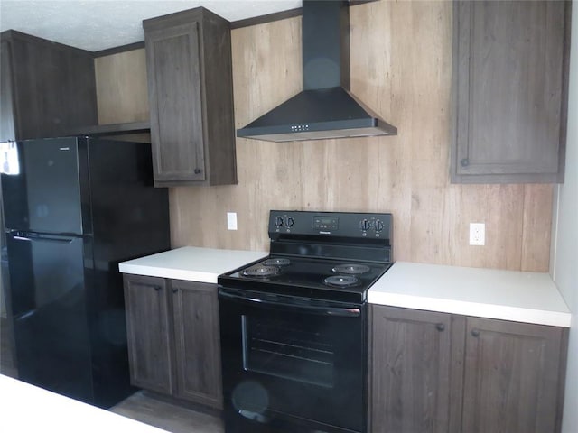 kitchen with black appliances and wall chimney exhaust hood