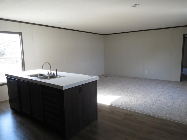 kitchen featuring sink, crown molding, dark hardwood / wood-style floors, black dishwasher, and an island with sink