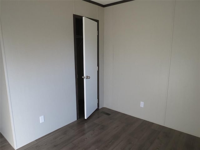 unfurnished bedroom featuring dark hardwood / wood-style flooring