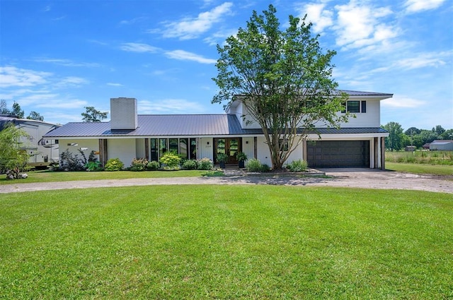 view of front of house featuring a garage and a front yard