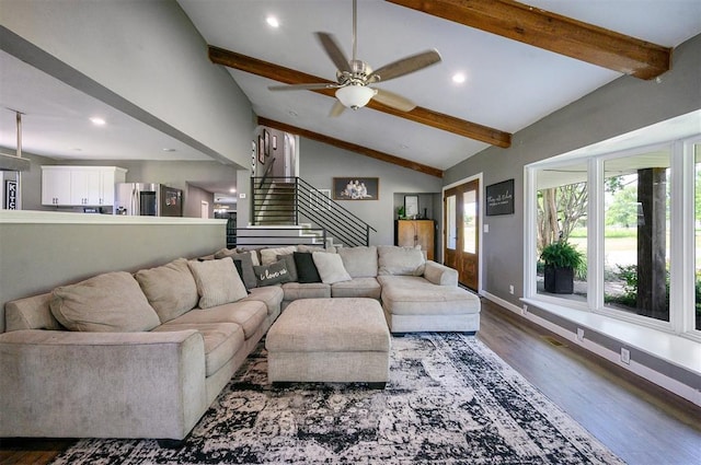 living room featuring lofted ceiling with beams, dark hardwood / wood-style floors, and ceiling fan