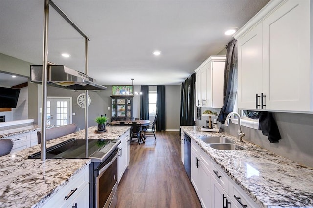 kitchen featuring stainless steel appliances, sink, pendant lighting, and white cabinets