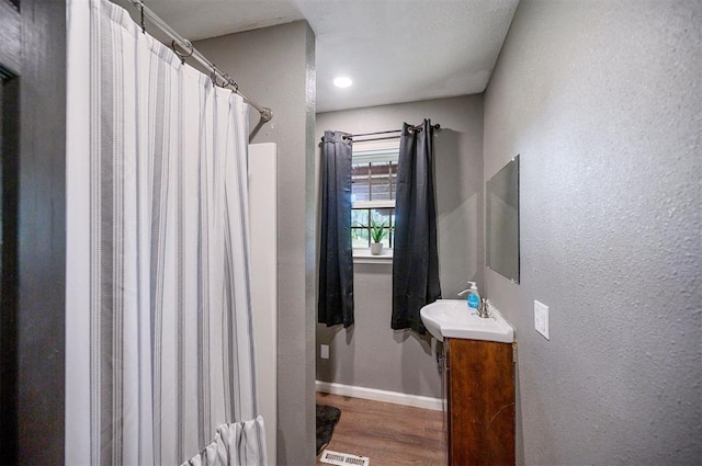 bathroom featuring vanity and wood-type flooring