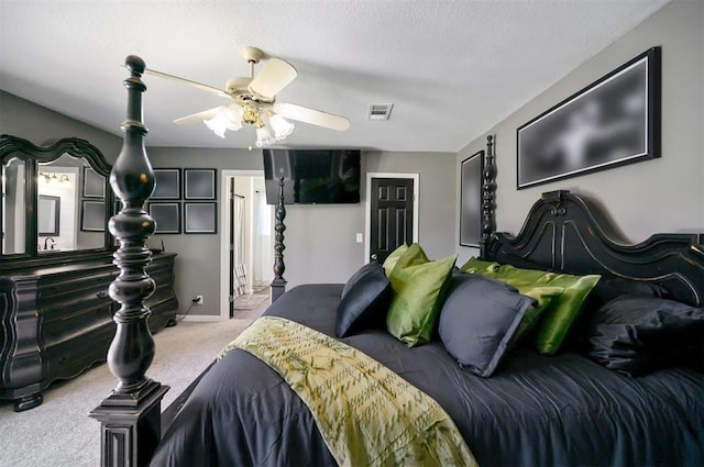 carpeted bedroom with ceiling fan and a textured ceiling