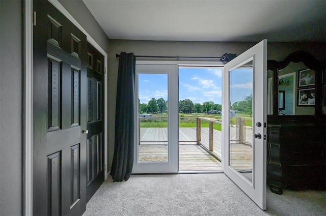 doorway to outside featuring french doors and carpet floors