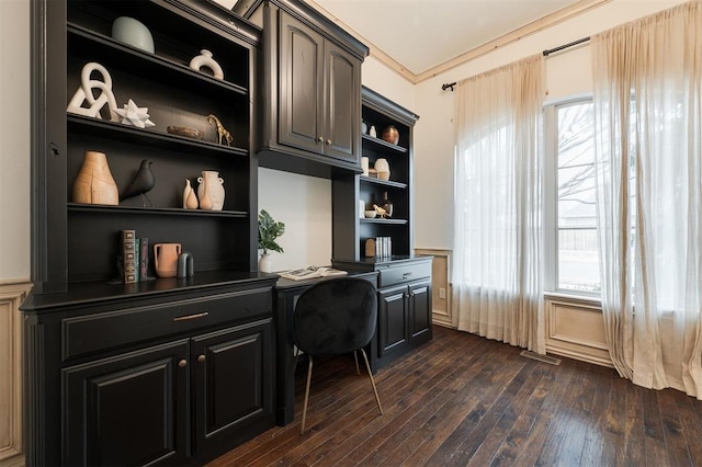 office featuring crown molding, dark hardwood / wood-style flooring, built in desk, and built in features