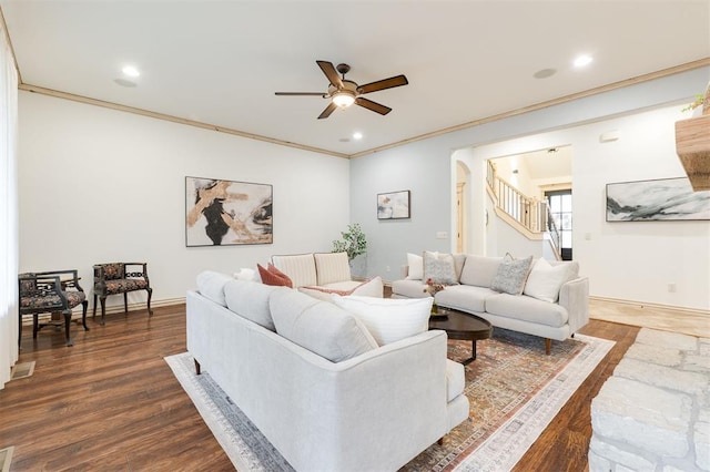 living room featuring ceiling fan, ornamental molding, and dark hardwood / wood-style floors