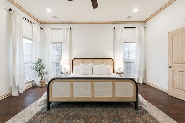 bedroom featuring dark hardwood / wood-style flooring, ornamental molding, and ceiling fan