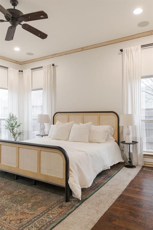 bedroom featuring crown molding, ceiling fan, and dark wood-type flooring