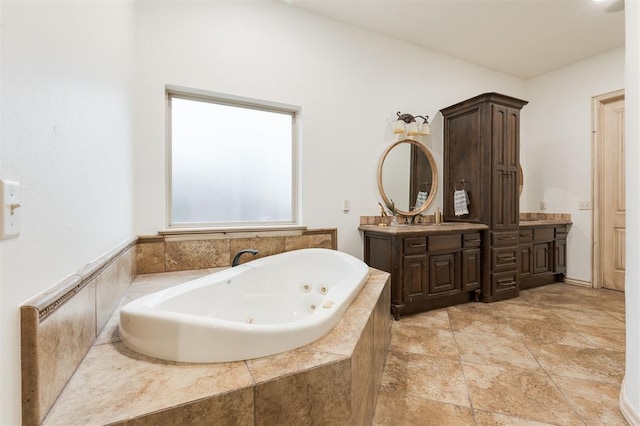 bathroom with a relaxing tiled tub and vanity