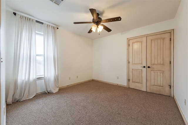 unfurnished bedroom with light carpet, a closet, and ceiling fan