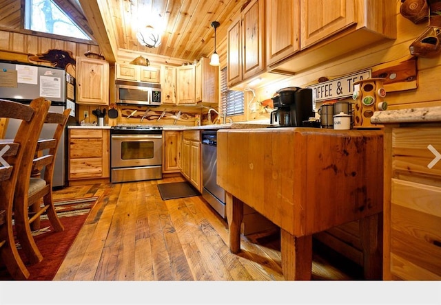 kitchen featuring wooden ceiling, stainless steel appliances, wood finished floors, light countertops, and decorative light fixtures