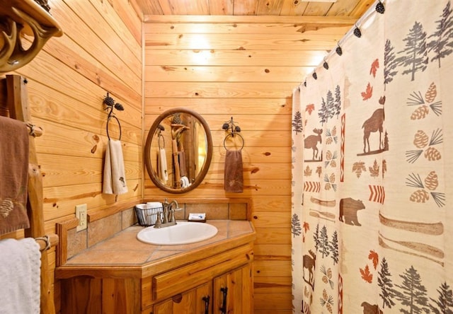 full bathroom with wood ceiling, wooden walls, and vanity