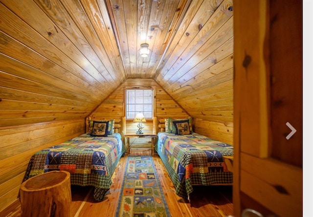 bedroom featuring lofted ceiling, wood ceiling, wood walls, and wood finished floors