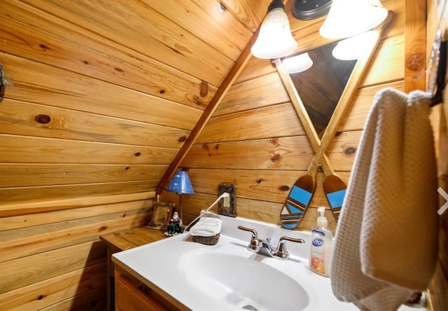 bathroom featuring wood walls and vanity