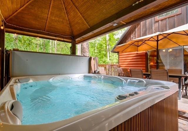 view of pool featuring a hot tub and a gazebo