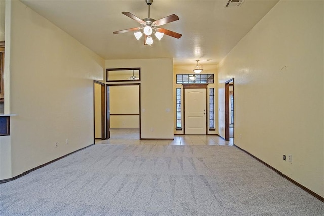 carpeted empty room with ceiling fan