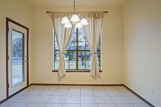 unfurnished dining area featuring a chandelier and light tile patterned floors