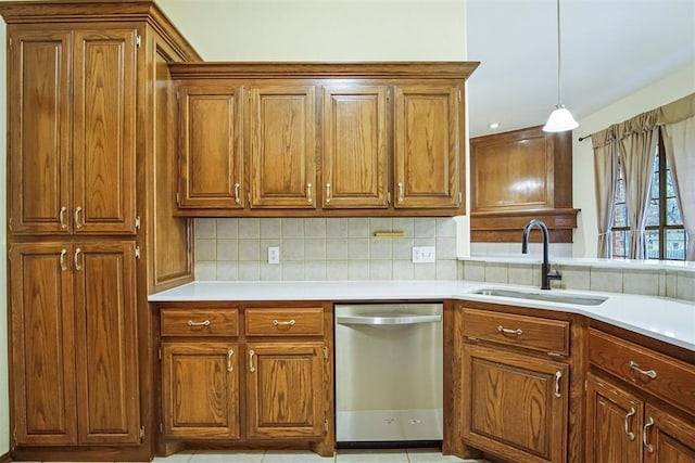 kitchen featuring sink, decorative backsplash, stainless steel dishwasher, and hanging light fixtures