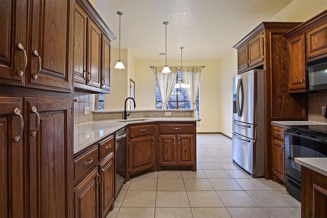 kitchen with pendant lighting, sink, light tile patterned floors, black appliances, and kitchen peninsula