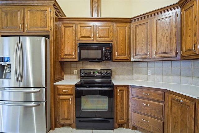 kitchen with backsplash, black appliances, and light tile patterned flooring