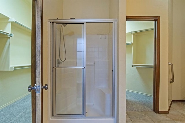 bathroom featuring a shower with shower door