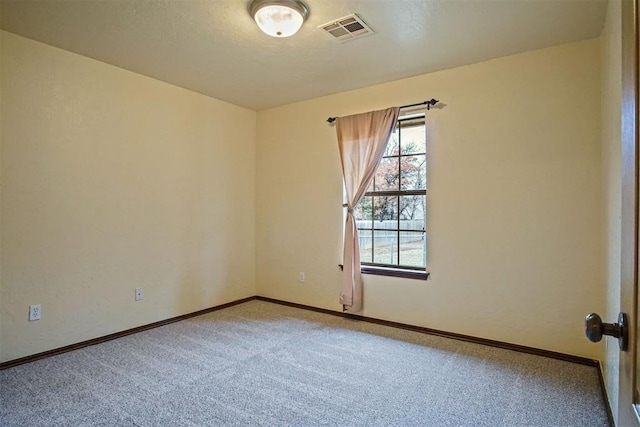 unfurnished room with carpet floors and a textured ceiling