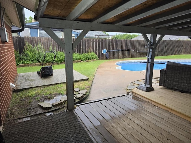 view of swimming pool with a wooden deck and a patio