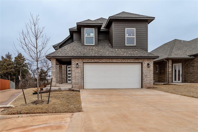 view of front of house featuring a garage, driveway, brick siding, and roof with shingles