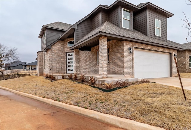 view of front of house featuring concrete driveway, brick siding, a front lawn, and an attached garage