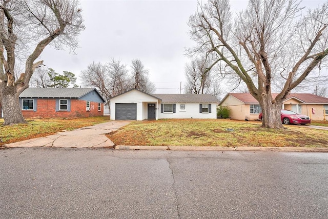 single story home featuring a garage and a front yard