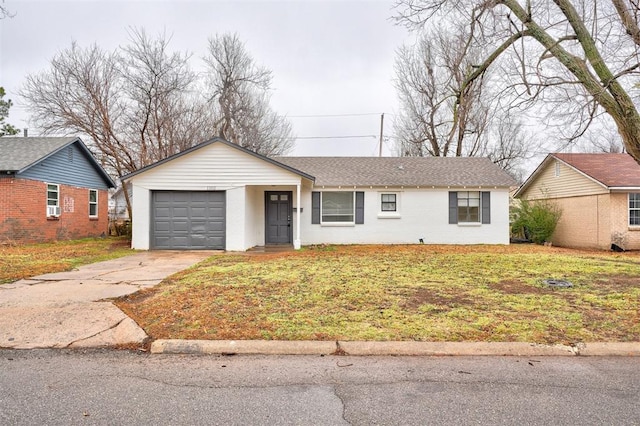 ranch-style home featuring a garage and a front lawn