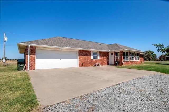 single story home featuring a garage and a front lawn