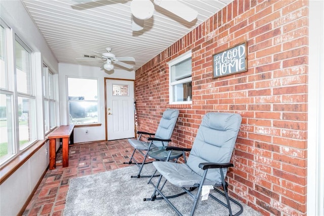 sunroom / solarium with ceiling fan