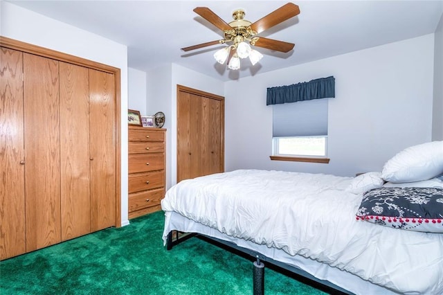 carpeted bedroom with two closets and ceiling fan