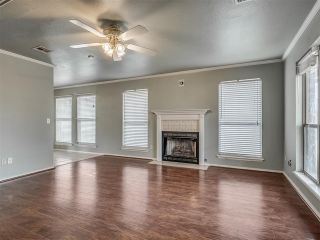 unfurnished living room featuring a textured ceiling, a fireplace, wood finished floors, and visible vents