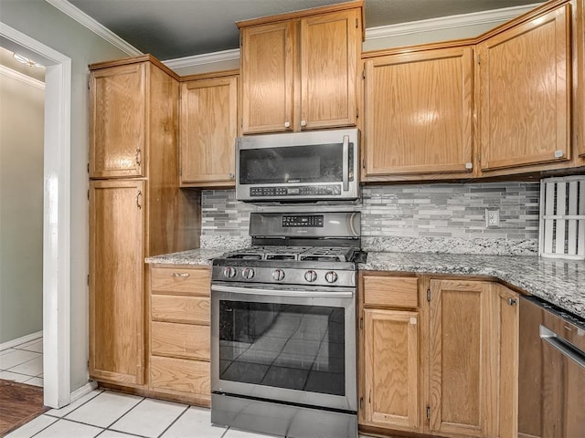 kitchen featuring light tile patterned flooring, stainless steel appliances, light stone countertops, tasteful backsplash, and crown molding