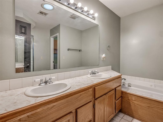 bathroom featuring a bath, double vanity, a sink, and tile patterned floors