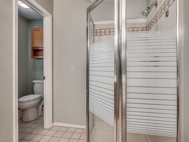 full bathroom with a stall shower, tile patterned flooring, and toilet