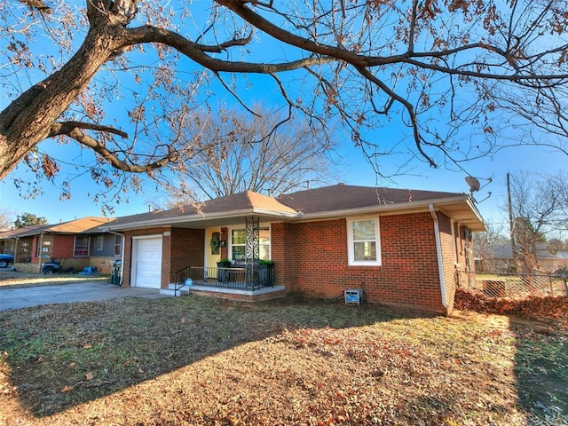 ranch-style home with a garage and covered porch