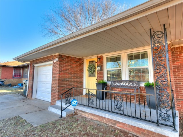 entrance to property featuring a porch and a garage